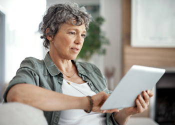 woman looks on tablet