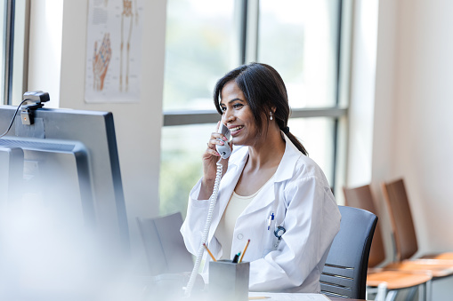 pharmacist on phone at her desk