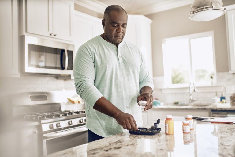 Man Standing at Kitchen Island